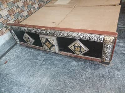 Beautiful traditional-style wooden bed with elegant silver and gold de