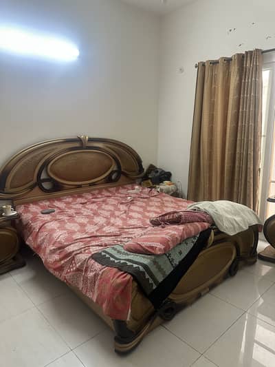 Bed with cupboard and side table