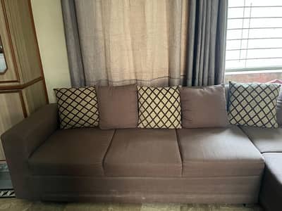 L shape Sofa with cushions.