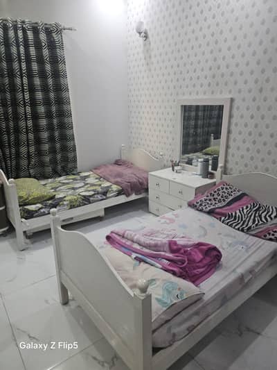 2 single beds with dresser along with study table.