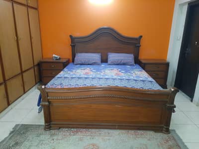 king size wooden bed along with matric and aide tables