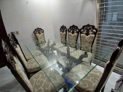8 seater heavy carved wooden dining table with glass top