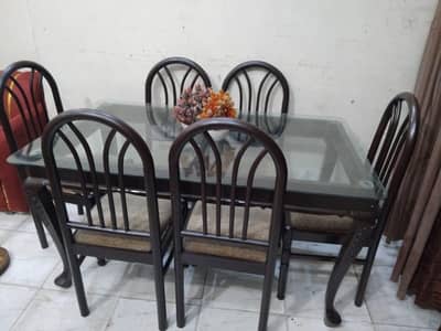 solid heavy wooden dinning with glass top