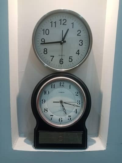 2 wall clocks (black and silver exterior)