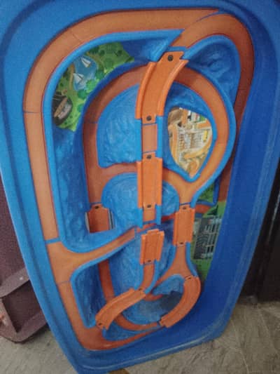 a table for sale specially designed for kids to play cars  and 1 small