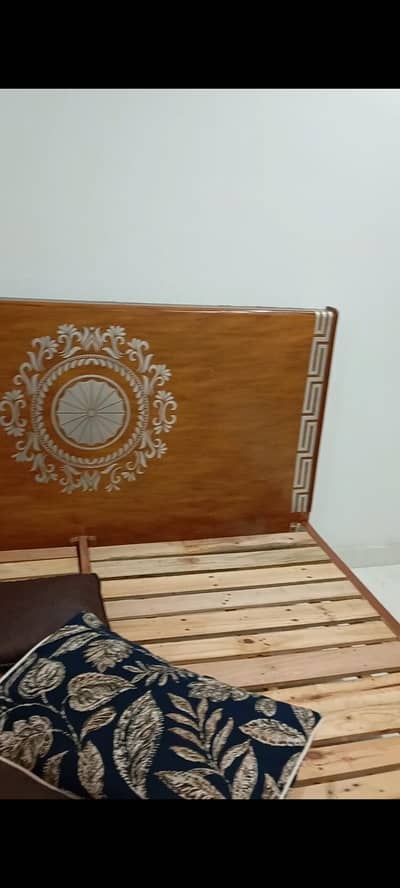 wooden bed with one side table . sale due to shifting