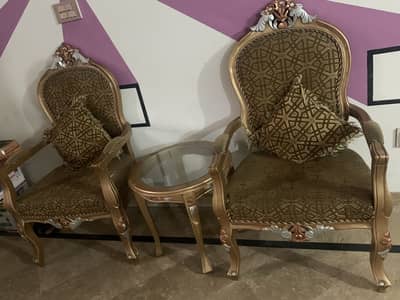 2 bed room chairs and a table