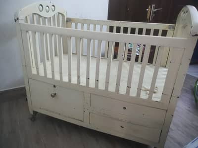 Solid wood crib with storage and lockable wheels