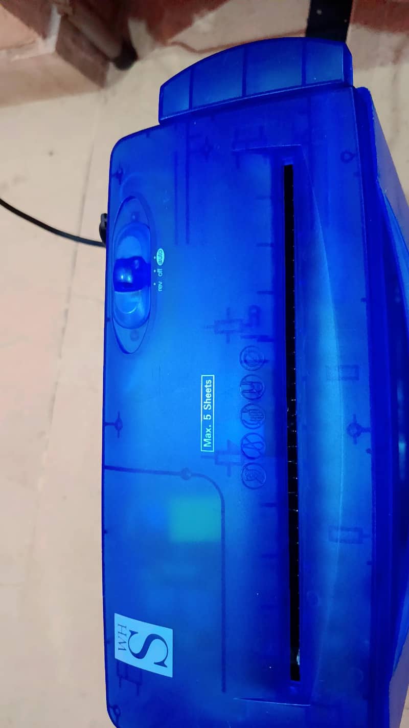 Blue translucent paper shredder "Max. 5 Sheets featuring reverse,auto 4