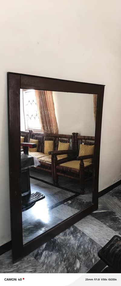 A mirror and a chair for parlor