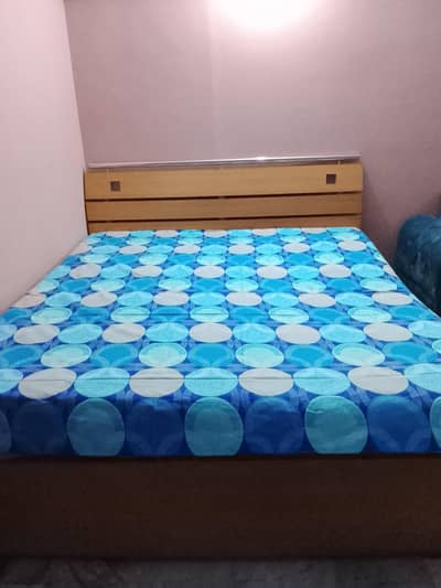 wooden bed with mattress
