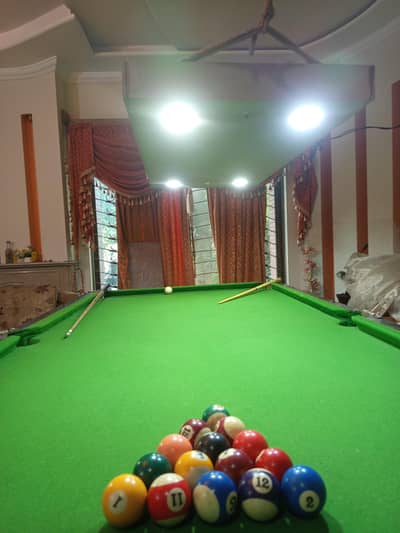 snooker, billiards table with 16 ballast and hanging lights.