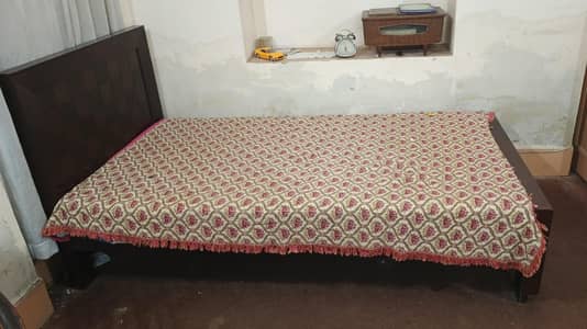 single wooden bed with matress