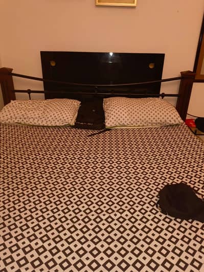 wooden and iron bed