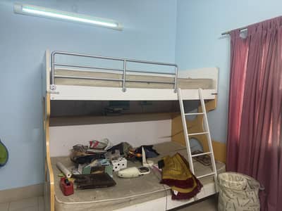 Double beds for kids with wooden cupboard plus wooden almirah decor