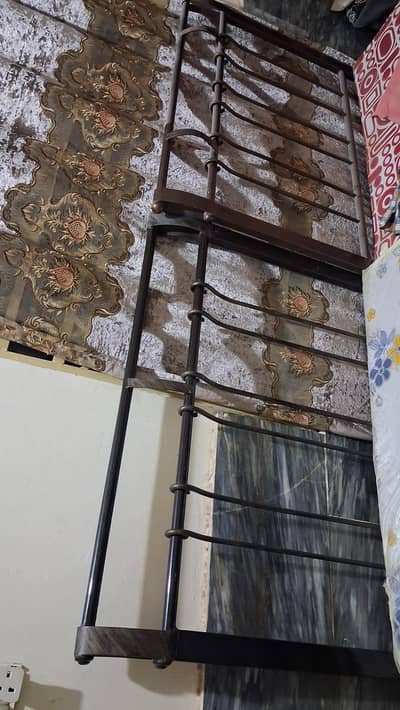 single iron bed with mattress sheet and grill