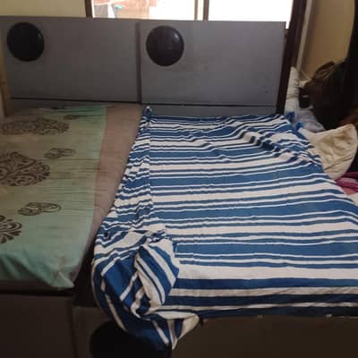 wooden single bed with mattress