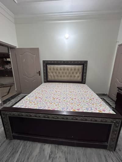 A king size bed with two side tables with dressings table