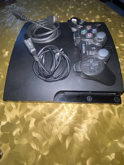 playstation 3 slim edition with one controller and original wires