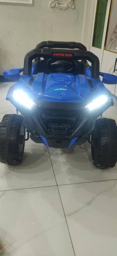 blue and black car with charger and remote . all buttons are functional