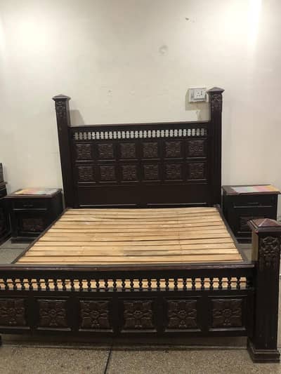 King size wooden bed with bedside tables