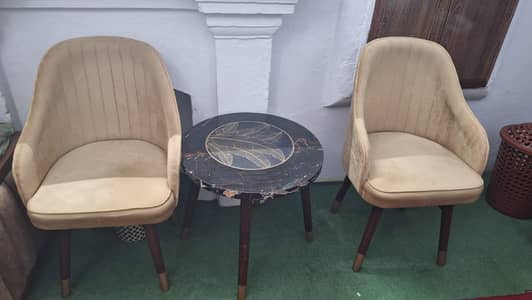Modern,comfortable sofa chairs with round bright marble look table.