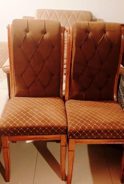 6 seater wooden dining table set with tufted velvet chairs.