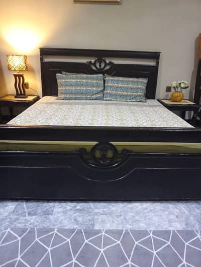 wooden bed and dressing table