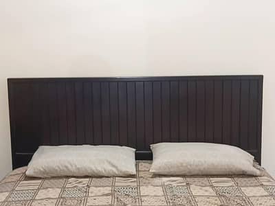 Wooden bed with mattress