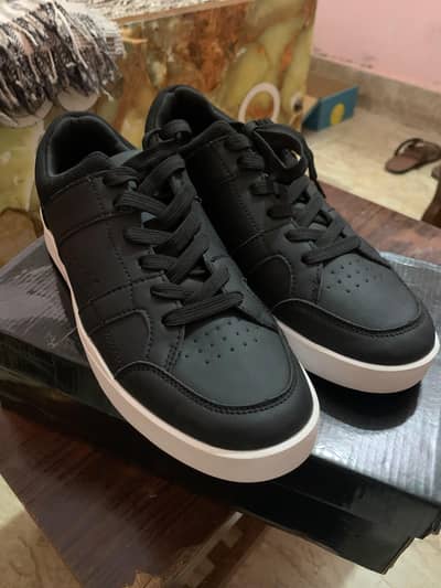 black leather sneaker with white sole branded