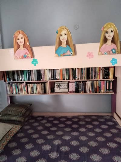 A pinkish bunk bed with bookcase drawers and cabinets