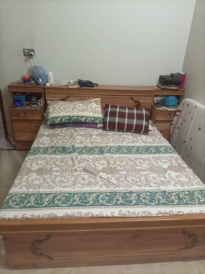 solid wooden bed with matching side tables