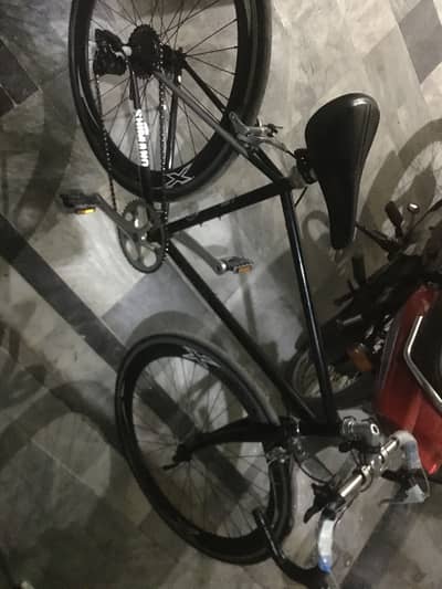Racing cycle with four brakes