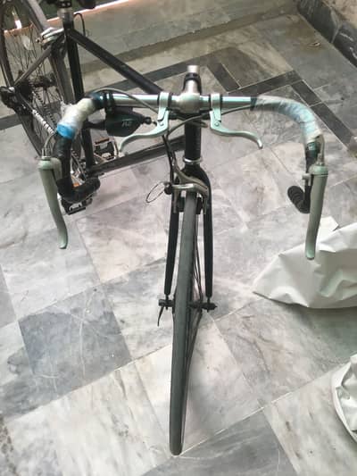 Racing cycle with four brakes