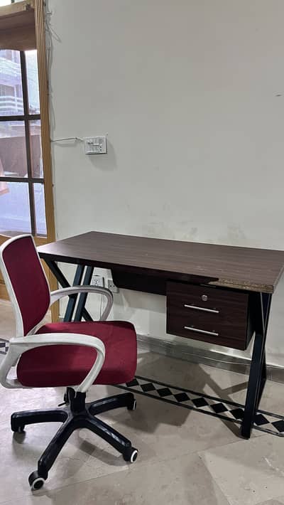 Study/Office table with revolving chair. Used but looks like new