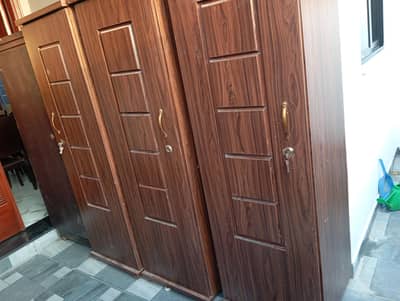 Brown colored three door clean wardrobe