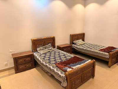 Two Single Wooden Beds with Side Tables
