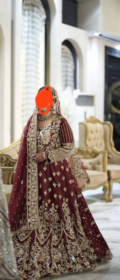 bridal maxy in maroon shade with multiple embellishments