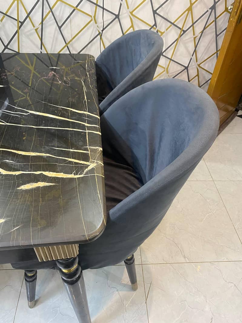 dining table with four chairs,, marble top,, with chairs covers also 4