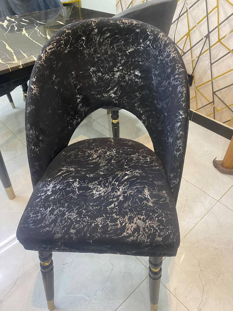 dining table with four chairs,, marble top,, with chairs covers also 6