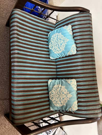 Used wooden 2 seater sofa/couch with blue cushions
