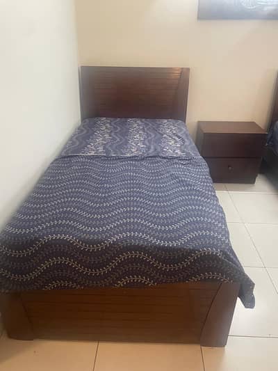 two single beds with two side tables in perfect condition