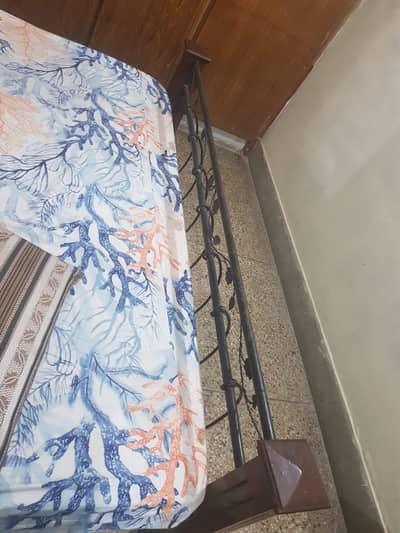 Bed with king size mattress along size table