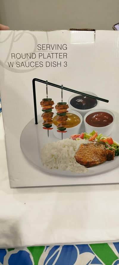 Serving round platter with sauces dishes