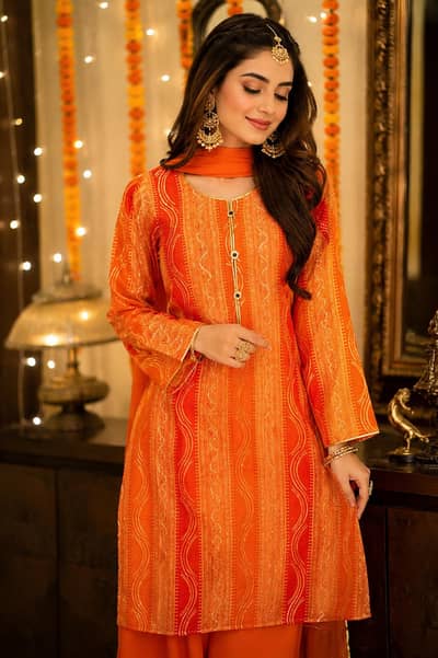 red and orange shalwar suit with duppata and black shirt and white