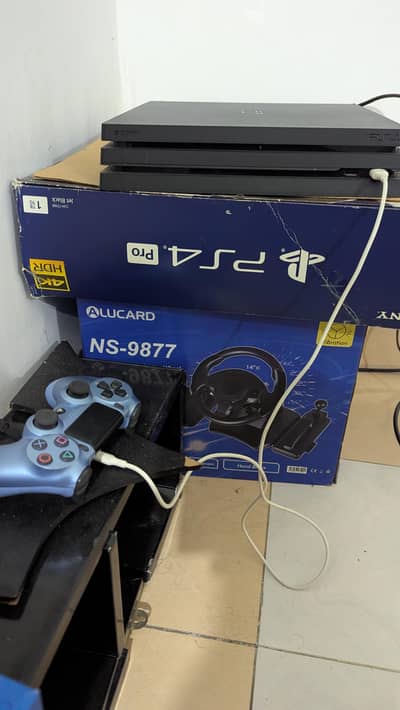 Playstation 4 Pro, 1 TB with box, steering wheel,3 controllers, 4 game
