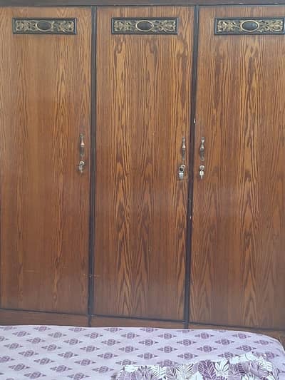 King size bed with 2 side tables, one dresser and 3 door cupboard.