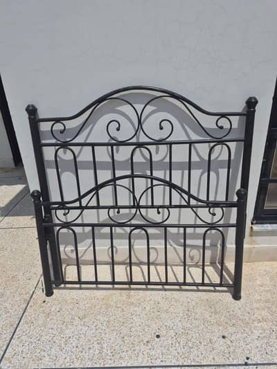 2 wrought iron beds with one side table