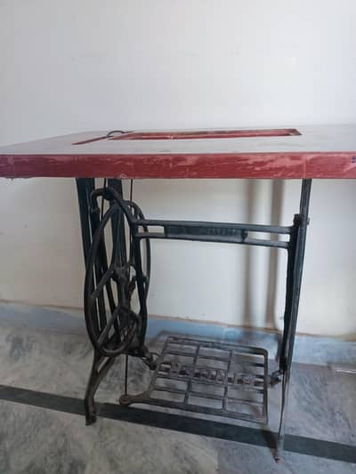 Manual treadle sewing machine.