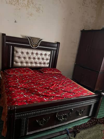 Wooden bed with mattress